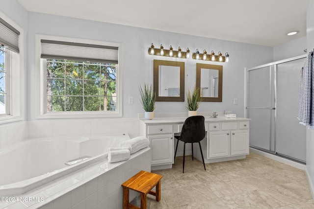 bathroom featuring a stall shower, vanity, and a bath