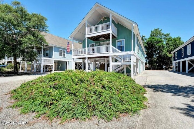 raised beach house featuring a balcony