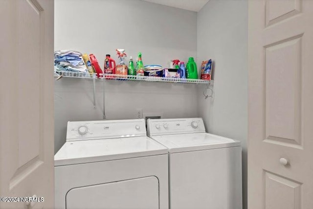 clothes washing area featuring independent washer and dryer