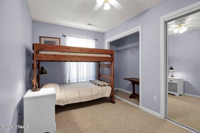 bedroom featuring a closet, carpet, a textured ceiling, and ceiling fan