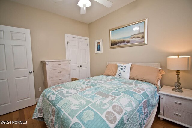 bedroom with ceiling fan, a closet, and dark hardwood / wood-style floors