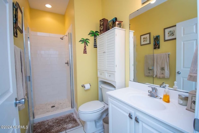 bathroom with vanity, tile patterned flooring, toilet, and an enclosed shower