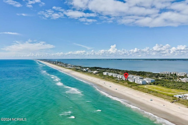 birds eye view of property with a water view and a beach view