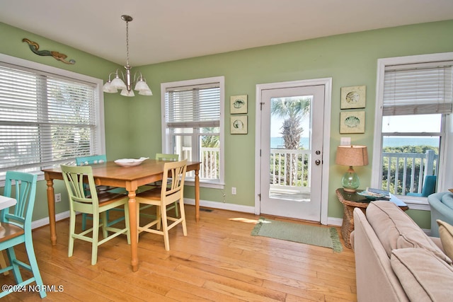 dining space featuring a chandelier and light hardwood / wood-style flooring