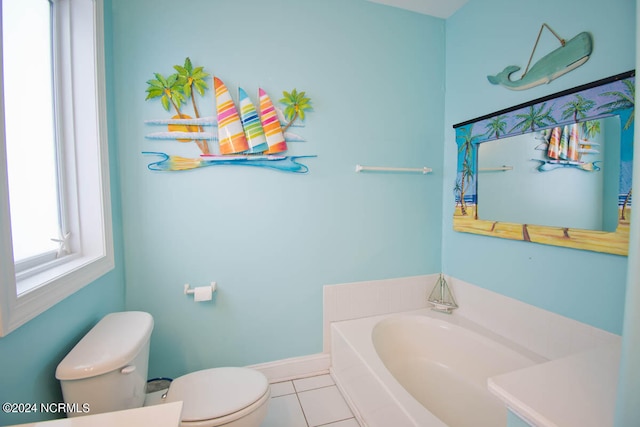 bathroom featuring tile patterned floors, a bathing tub, and toilet