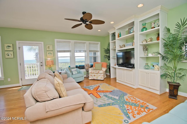 kitchen featuring stainless steel appliances, white cabinets, and light hardwood / wood-style flooring