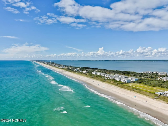 birds eye view of property with a view of the beach and a water view