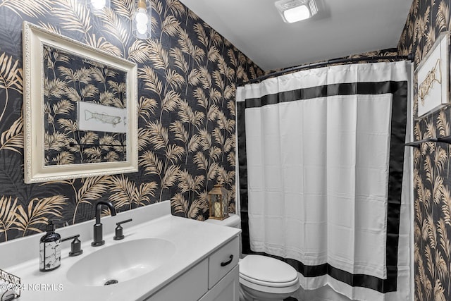 bathroom featuring vanity and toilet