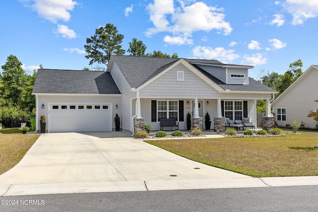 craftsman inspired home with a front lawn, a porch, and a garage