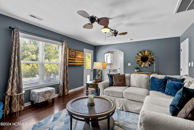 living room featuring dark hardwood / wood-style flooring and ceiling fan