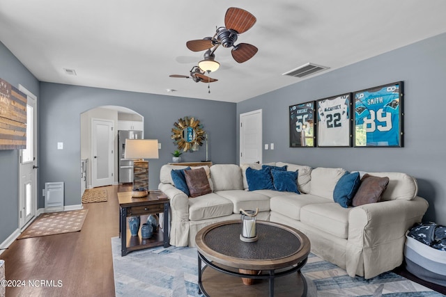 living room with hardwood / wood-style floors and ceiling fan