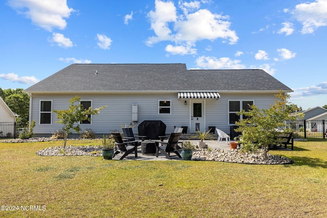 back of property with a yard and a patio