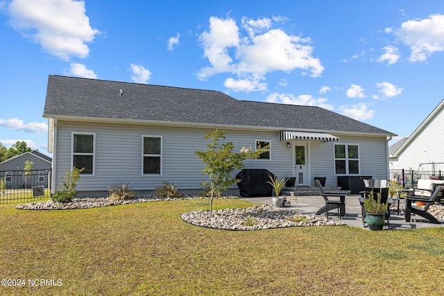 back of house featuring a yard and a patio