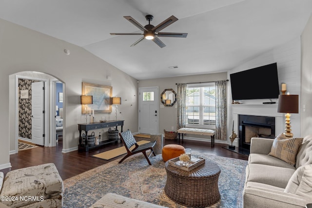 living room with ceiling fan, dark hardwood / wood-style flooring, and lofted ceiling