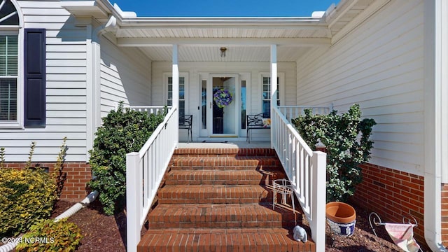 property entrance featuring covered porch