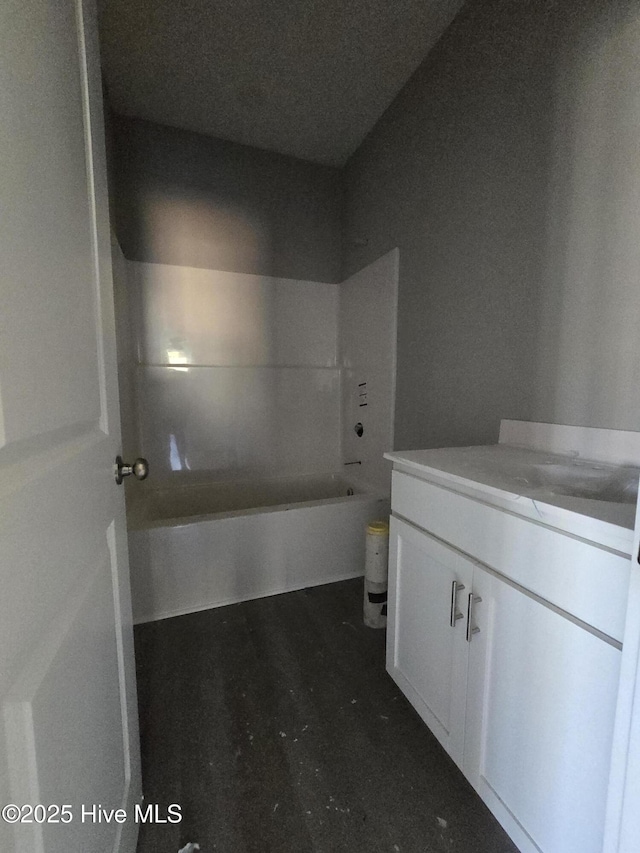 bathroom featuring  shower combination and vanity