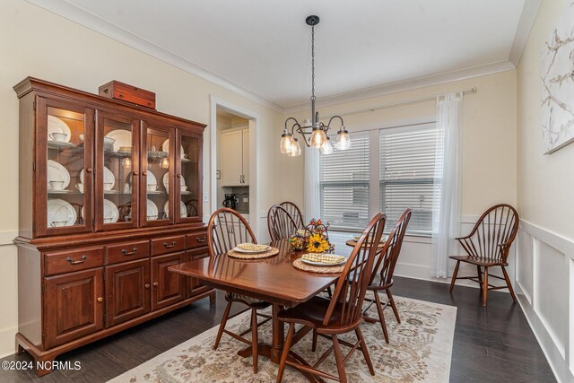 dining room with ornamental molding, dark wood-type flooring, and a chandelier