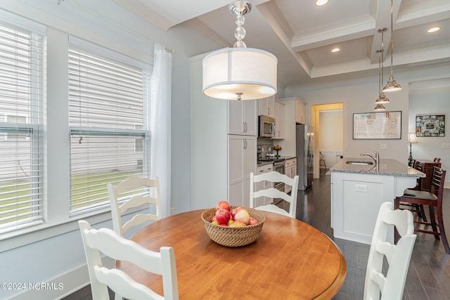 dining space featuring sink, beam ceiling, coffered ceiling, dark hardwood / wood-style flooring, and ornamental molding