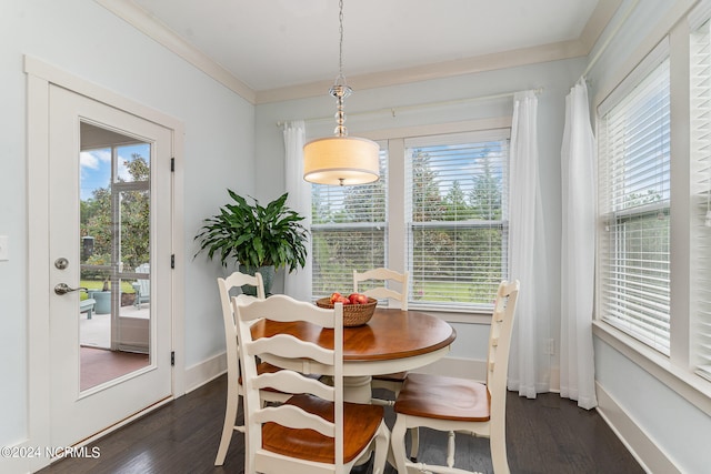 dining area with ornamental molding and dark wood-type flooring