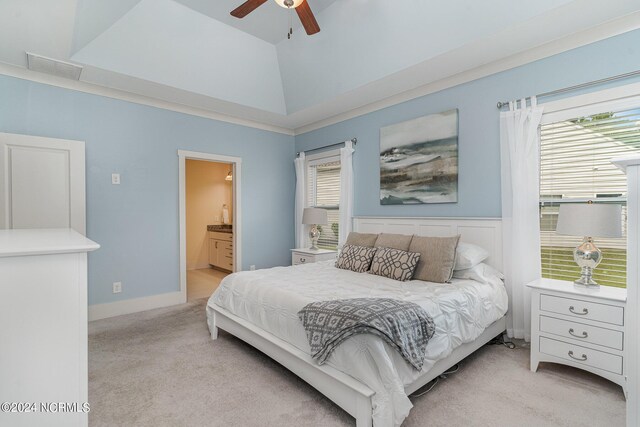 carpeted bedroom with lofted ceiling, ensuite bath, and ceiling fan