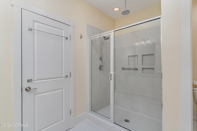 bathroom featuring walk in shower and tile patterned flooring