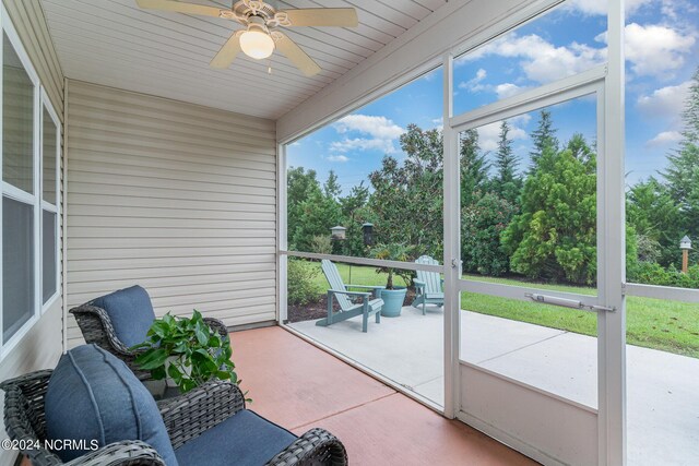 unfurnished sunroom with ceiling fan