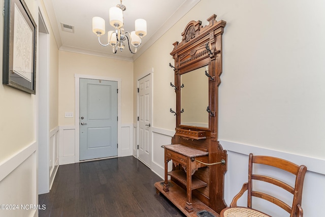 foyer with ornamental molding, a notable chandelier, and dark hardwood / wood-style flooring