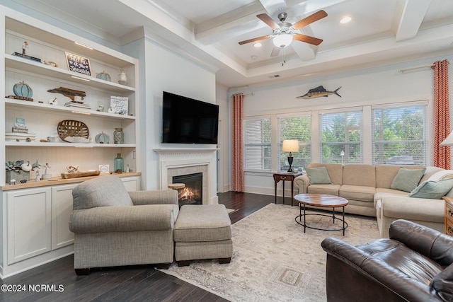 living room featuring beam ceiling, a tile fireplace, and dark wood-type flooring