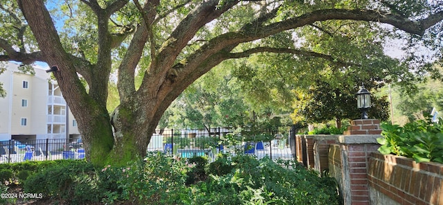 view of community with fence