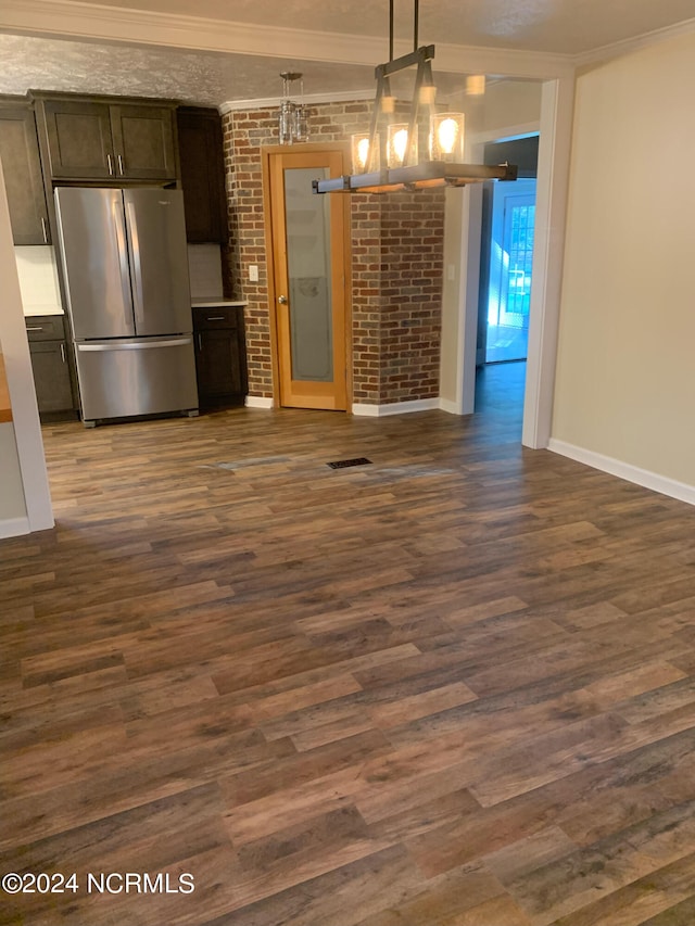 kitchen featuring stainless steel fridge, dark brown cabinetry, dark wood-type flooring, and decorative light fixtures