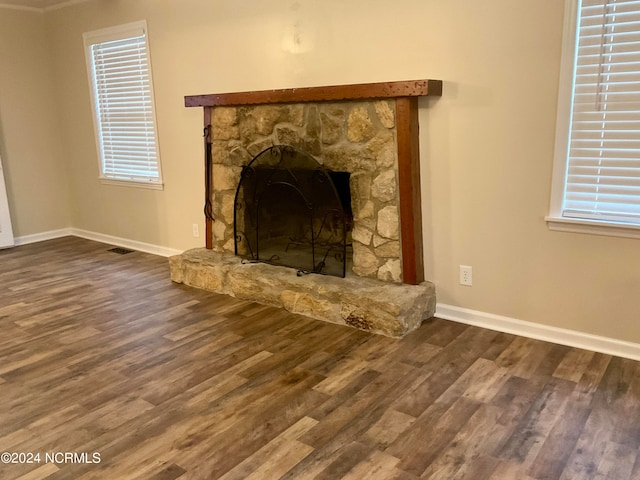 room details featuring hardwood / wood-style flooring and a stone fireplace