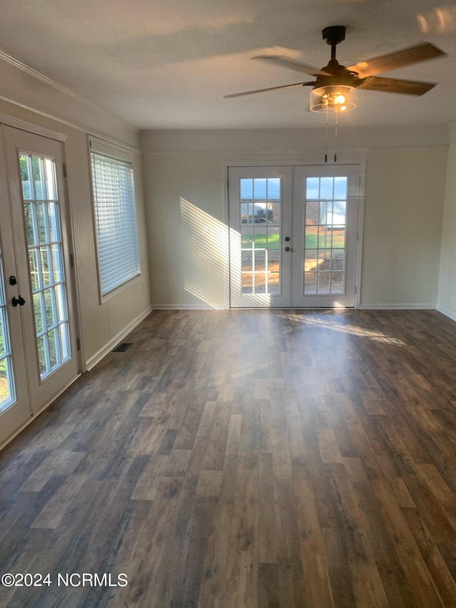 spare room featuring ceiling fan, french doors, and dark hardwood / wood-style flooring