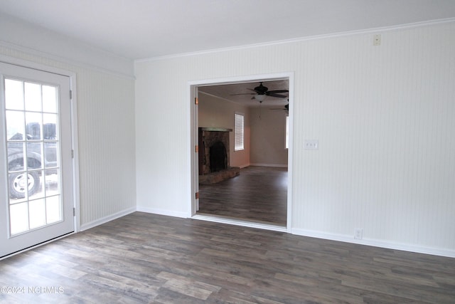 unfurnished room with ornamental molding, ceiling fan, and dark wood-type flooring