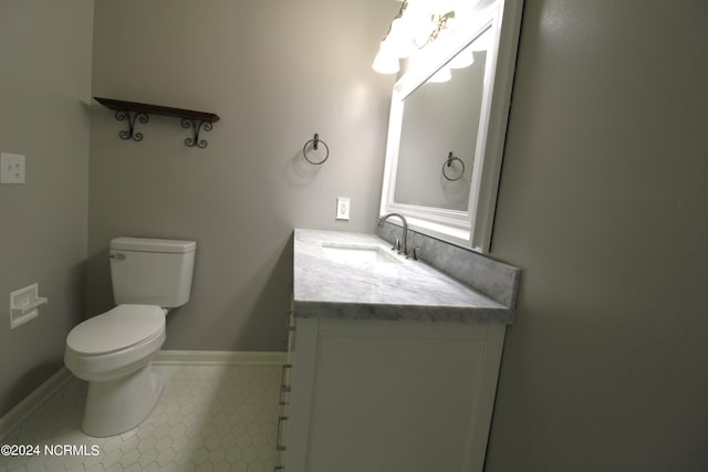 bathroom featuring vanity, tile patterned flooring, and toilet