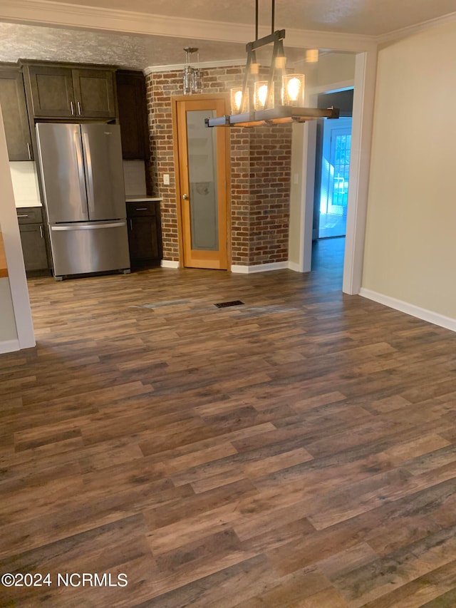 kitchen with stainless steel fridge, dark hardwood / wood-style flooring, decorative light fixtures, dark brown cabinetry, and ornamental molding