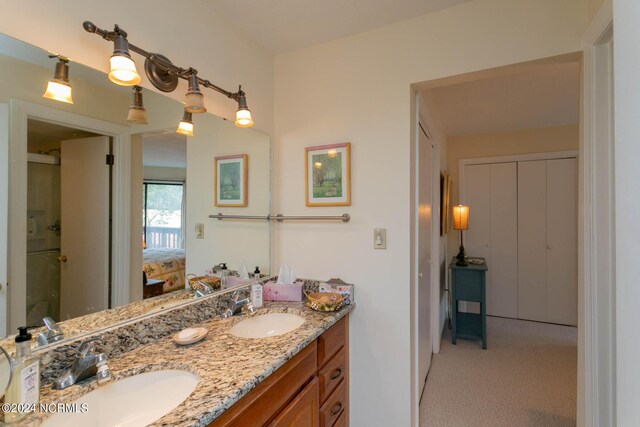 bathroom featuring vanity and an enclosed shower