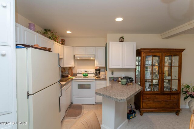 kitchen featuring light carpet, white cabinets, and white appliances