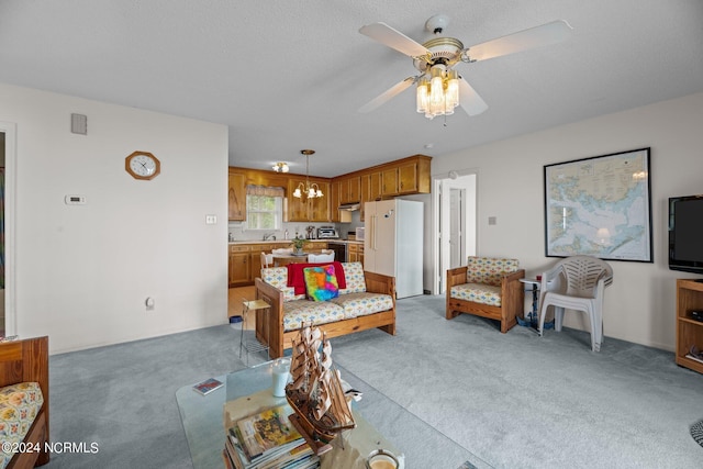 carpeted living room featuring ceiling fan with notable chandelier