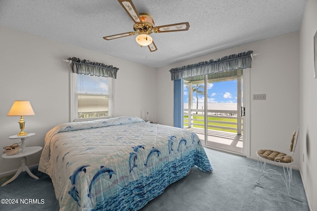 carpeted bedroom featuring access to exterior, a textured ceiling, and ceiling fan