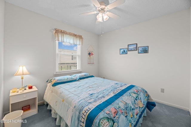 carpeted bedroom with ceiling fan and a textured ceiling