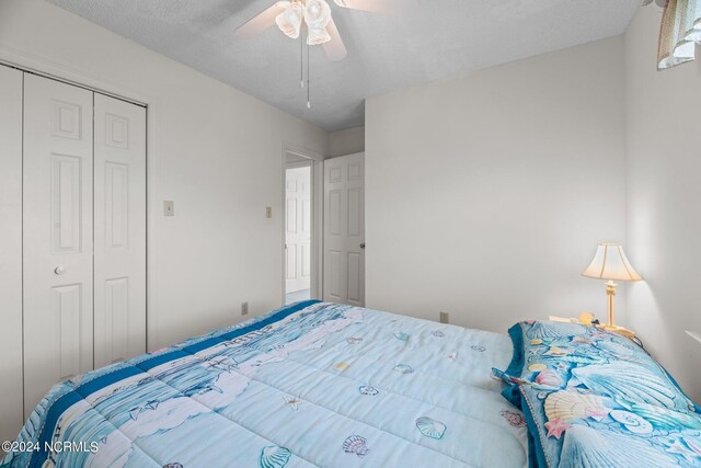 carpeted living room with a textured ceiling and ceiling fan