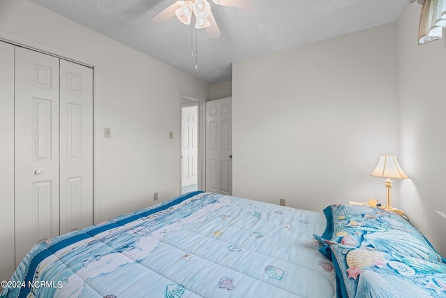 bedroom featuring a textured ceiling, a closet, and ceiling fan