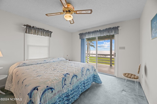 carpeted bedroom featuring ceiling fan, a textured ceiling, and access to outside