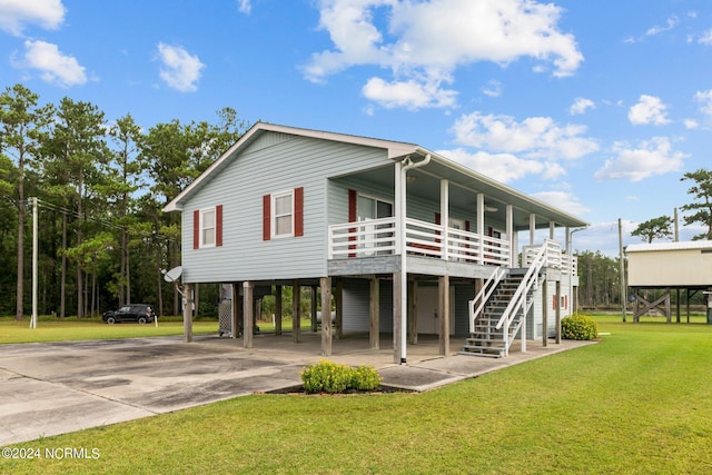 rear view of house featuring a yard and a carport