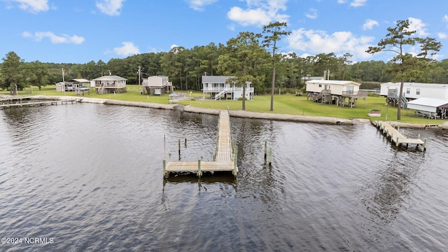 dock area with a yard and a water view