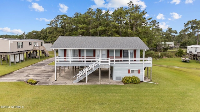 back of house featuring a carport and a lawn