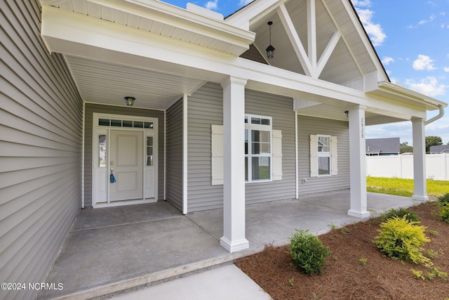 doorway to property featuring covered porch