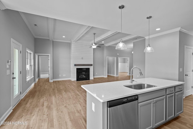 kitchen featuring dishwasher, beamed ceiling, sink, gray cabinets, and a kitchen island with sink