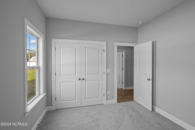 unfurnished bedroom featuring a closet and carpet flooring