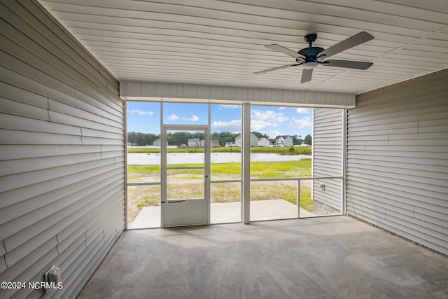 unfurnished sunroom featuring ceiling fan